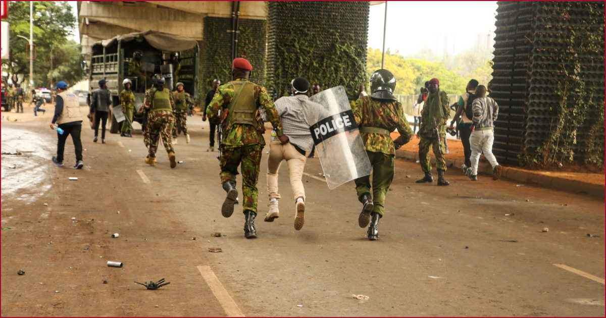 A protester being manhandled by the police in Nairobi.